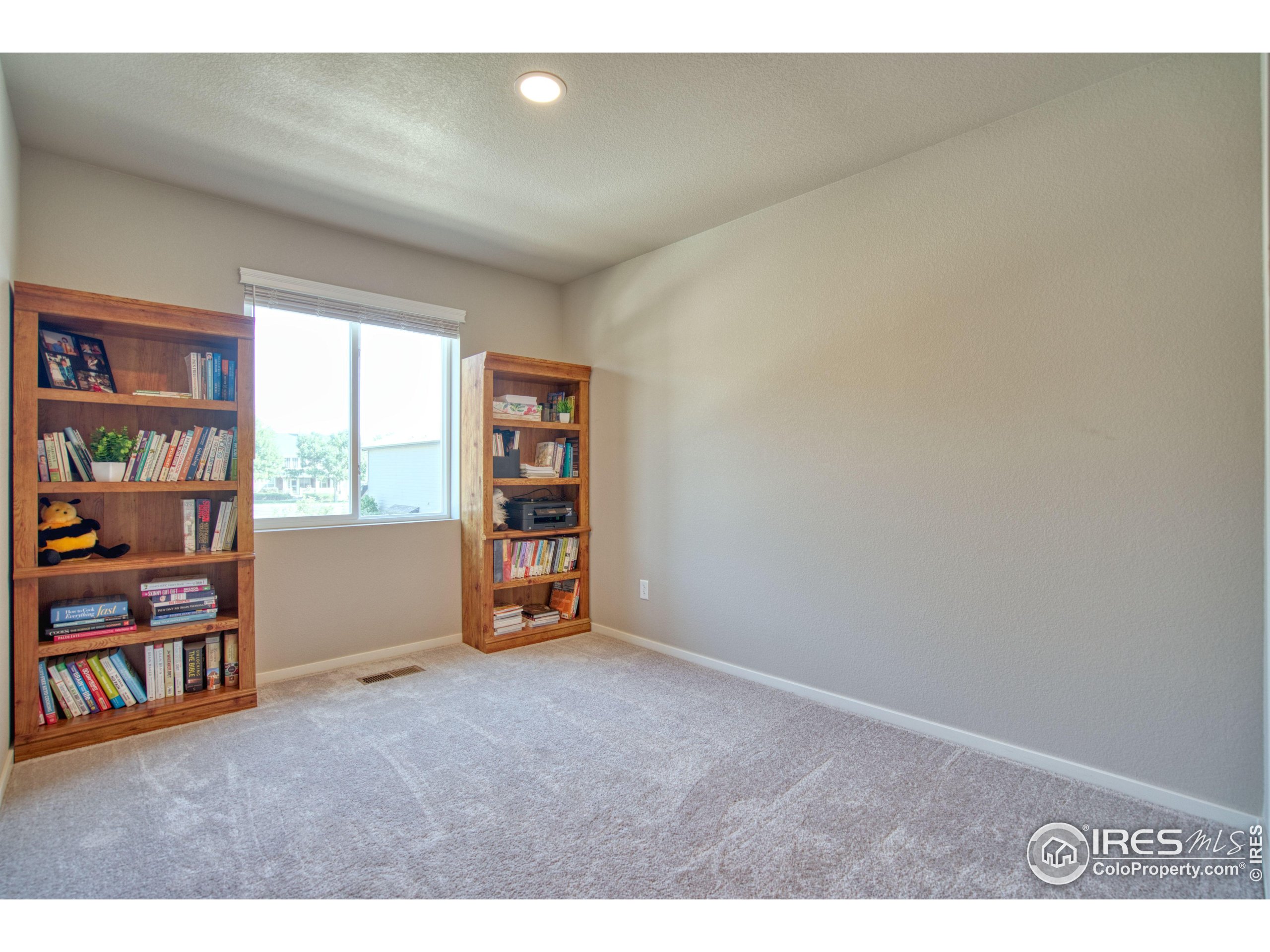 6615 4th St Road, Unit 2 Greeley, CO 80634 - Photo 15 of 31 a view of an empty room with shelves