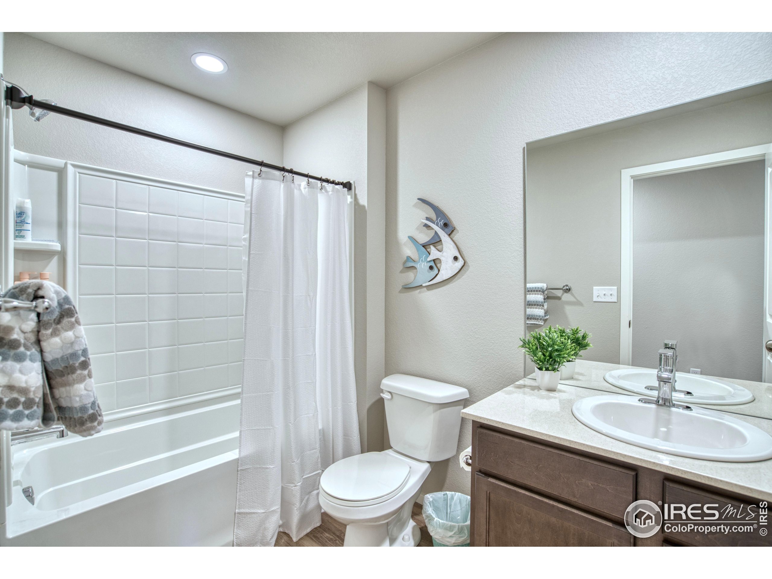 6615 4th St Road, Unit 2 Greeley, CO 80634 - Photo 18 of 31 a bathroom with a sink toilet and shower