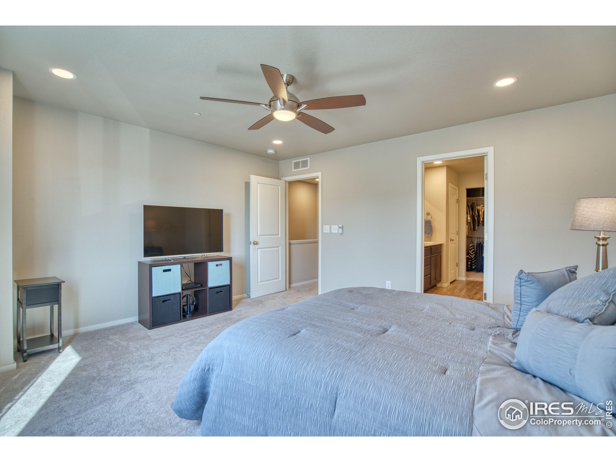 6615 4th St Road, Unit 2 Greeley, CO 80634 - Photo 9 of 31 a bedroom with a bed and a flat screen tv