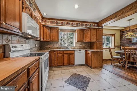 a kitchen with a sink a stove and cabinets