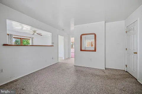 an empty room with windows and wooden door