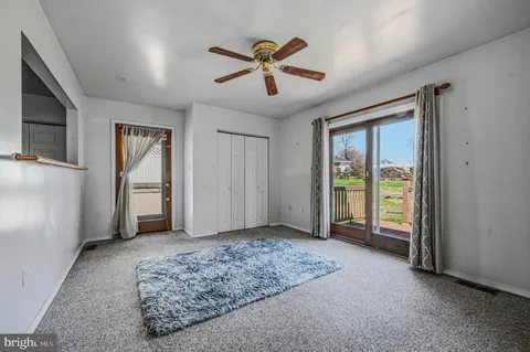 a view of livingroom with hardwood floor and ceiling fan