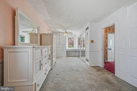a view of entryway with wooden floor and cabinet