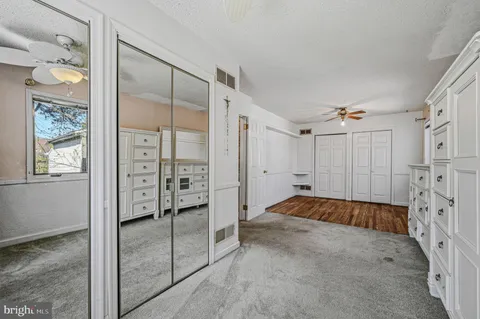 a bedroom with a bed and cabinet
