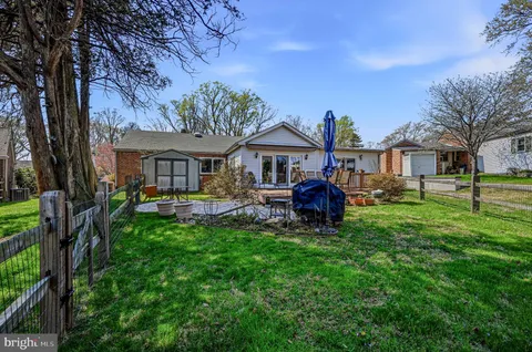 a view of a house with backyard sitting area and garden