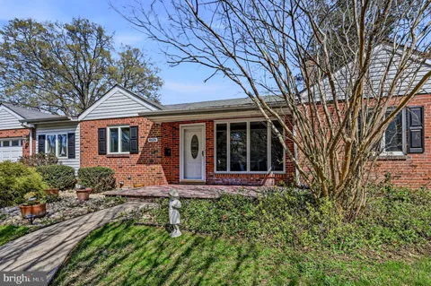 a front view of a house with yard and green space
