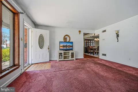 a view of an empty room with window and closet