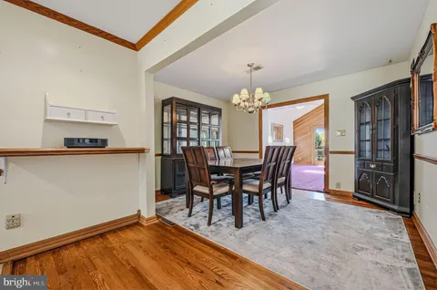 a view of a dining room with furniture and chandelier