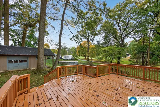 a view of backyard with swimming pool and outdoor seating