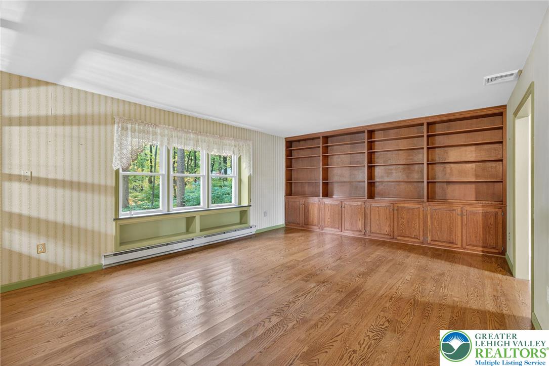 340 Chestnut Hill Road Emmaus, PA 18049 - Photo 21 of 49 a view of an empty room with wooden floor and a window