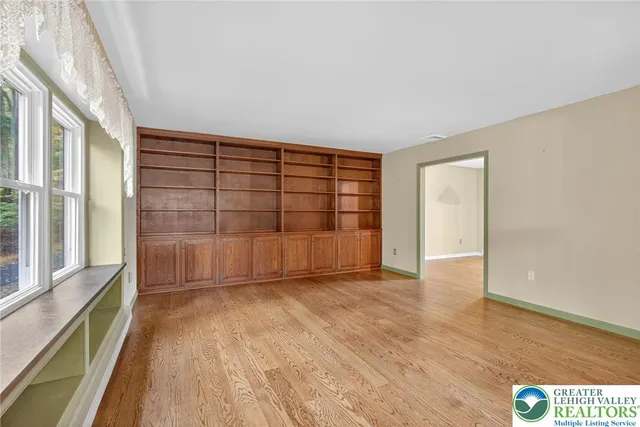 a view of empty room with wooden floor and cabinet