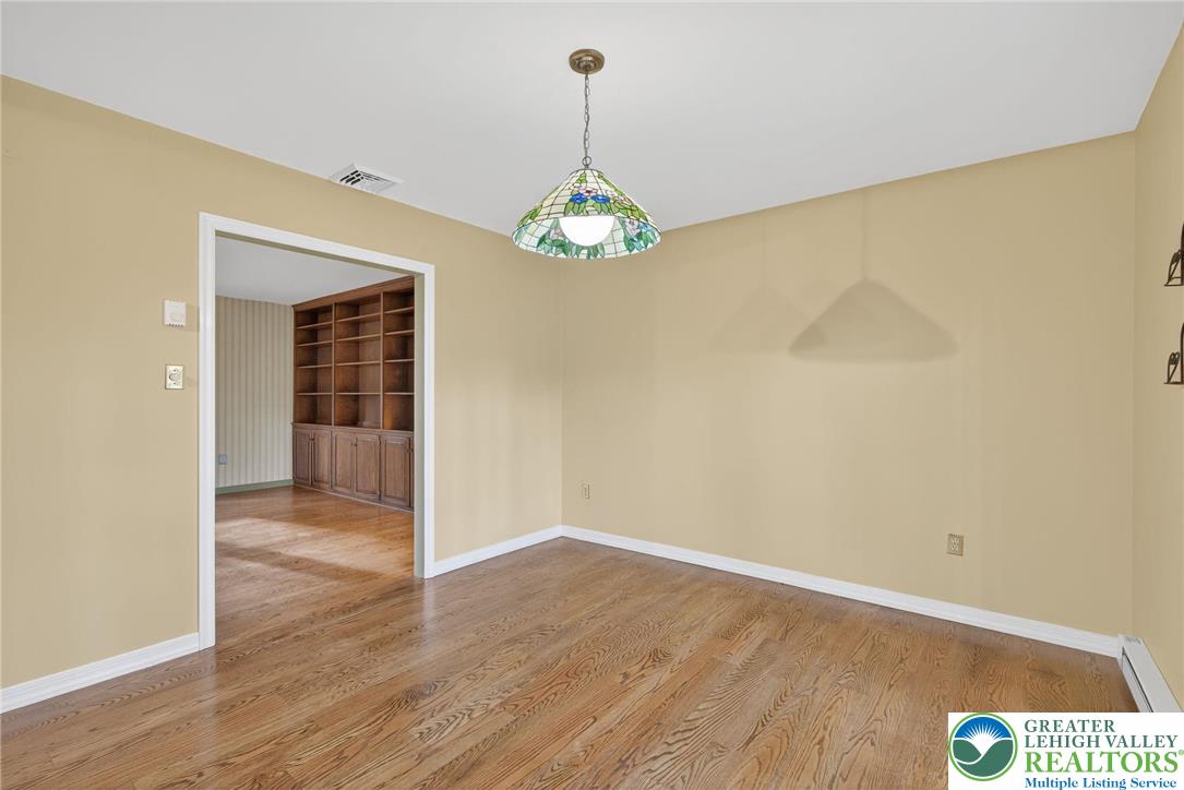 340 Chestnut Hill Road Emmaus, PA 18049 - Photo 30 of 49 a view of a hallway with wooden floor and a chandelier