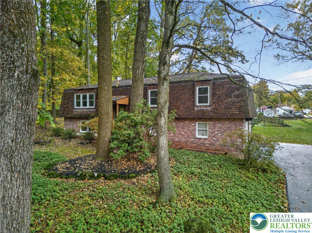 340 Chestnut Hill Road Emmaus, PA 18049 - Photo 3 of 49 a brick house with a tree in front of it