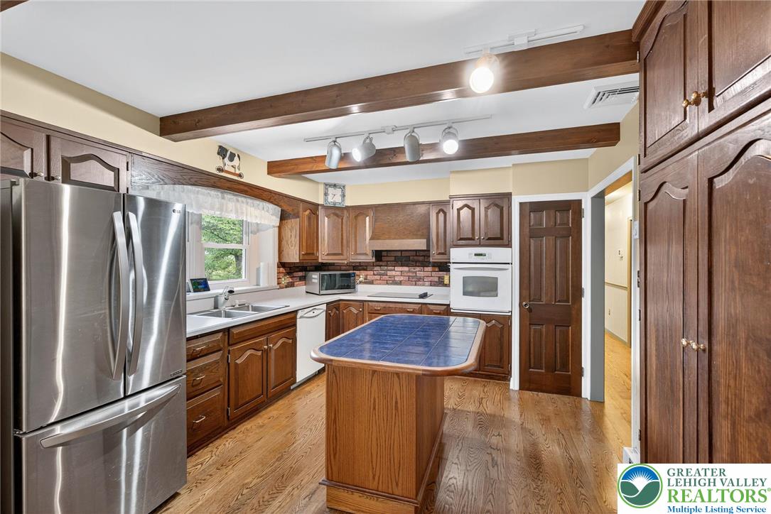 340 Chestnut Hill Road Emmaus, PA 18049 - Photo 31 of 49 a kitchen with stainless steel appliances granite countertop a refrigerator a sink and a stove