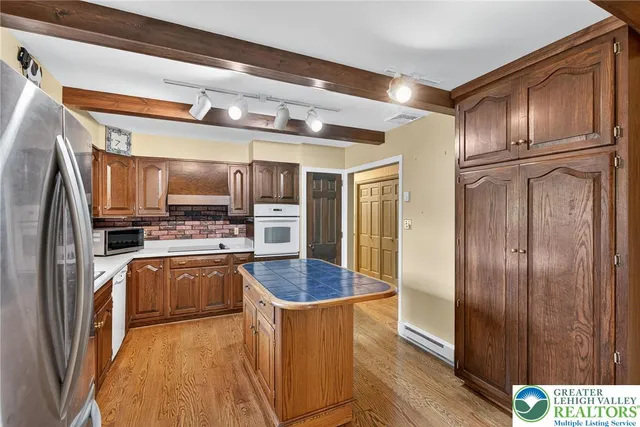 a kitchen with stainless steel appliances granite countertop a sink stove and wooden cabinets