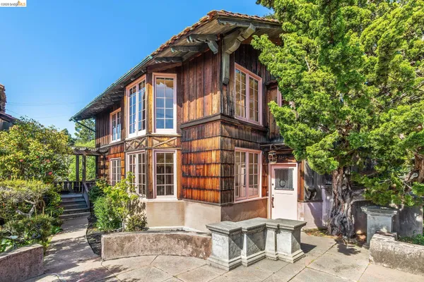 a view of a dining room with furniture and a potted plant