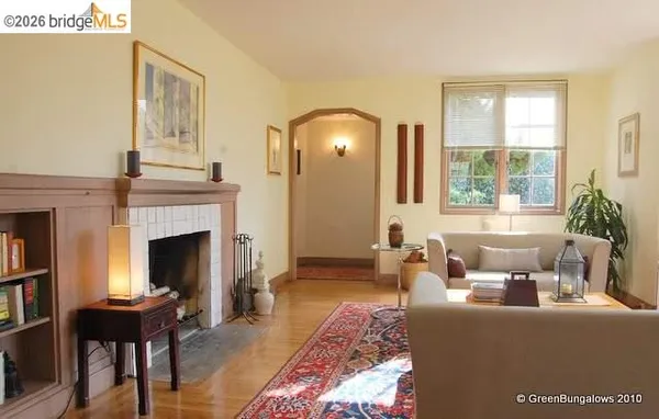 a view of empty room with wooden floor and fireplace