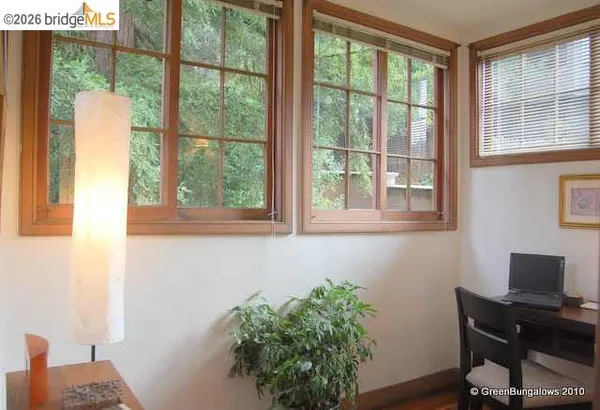 a view of empty room with window and wooden floor