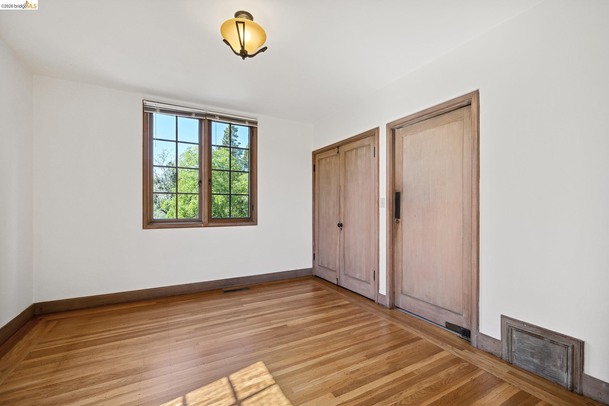 2501 Rose Walk Berkeley, CA 94708 - Photo 36 of 60 a view of an empty room with a window and wooden floor