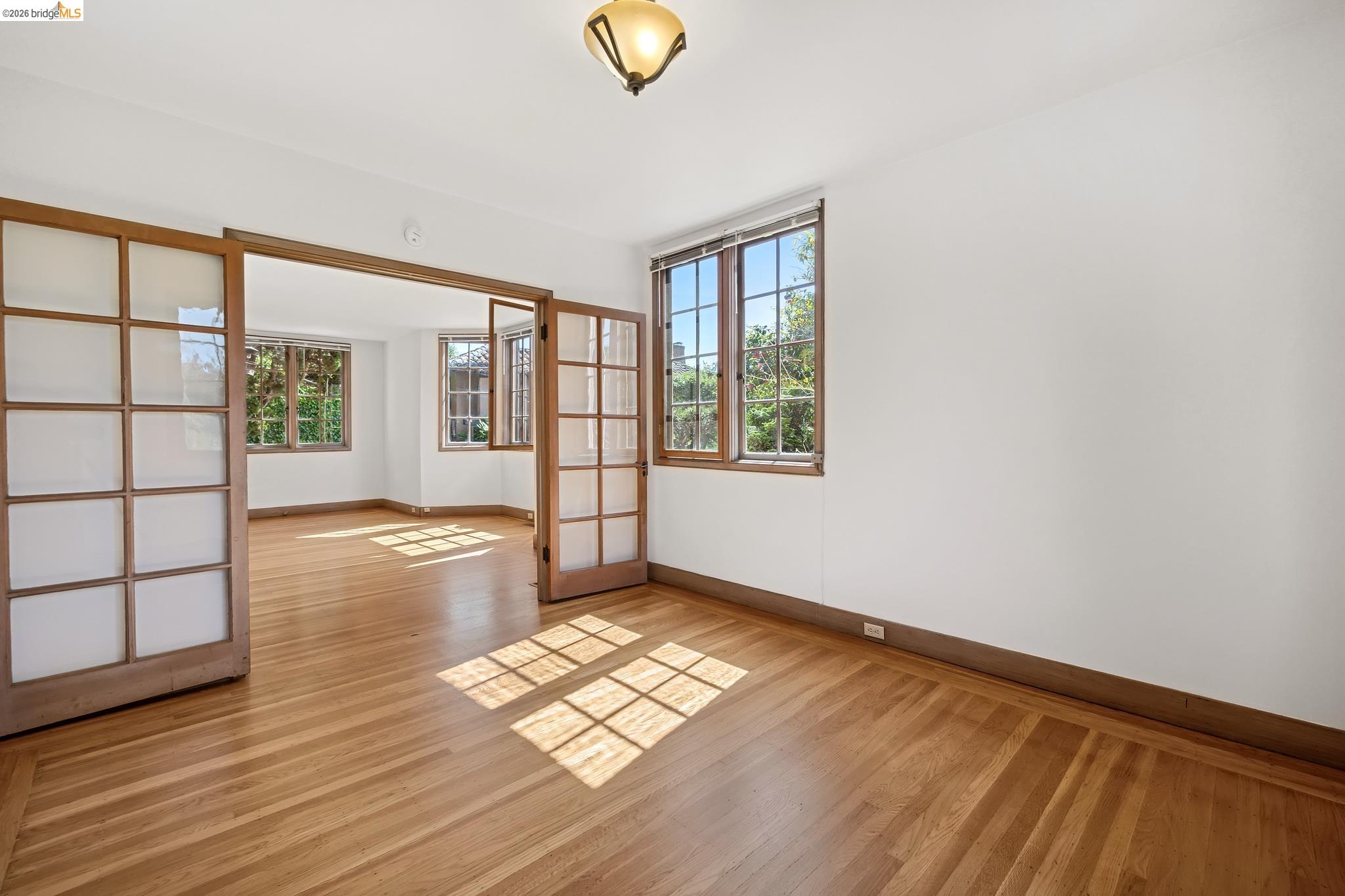 2501 Rose Walk Berkeley, CA 94708 - Photo 39 of 60 an empty room with wooden floor and windows