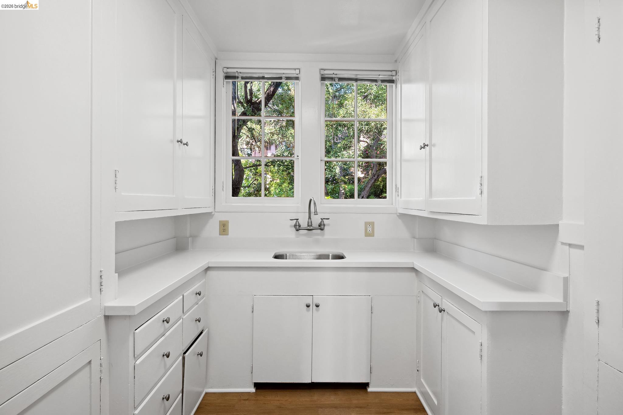 2501 Rose Walk Berkeley, CA 94708 - Photo 42 of 60 a kitchen with white cabinets and a sink