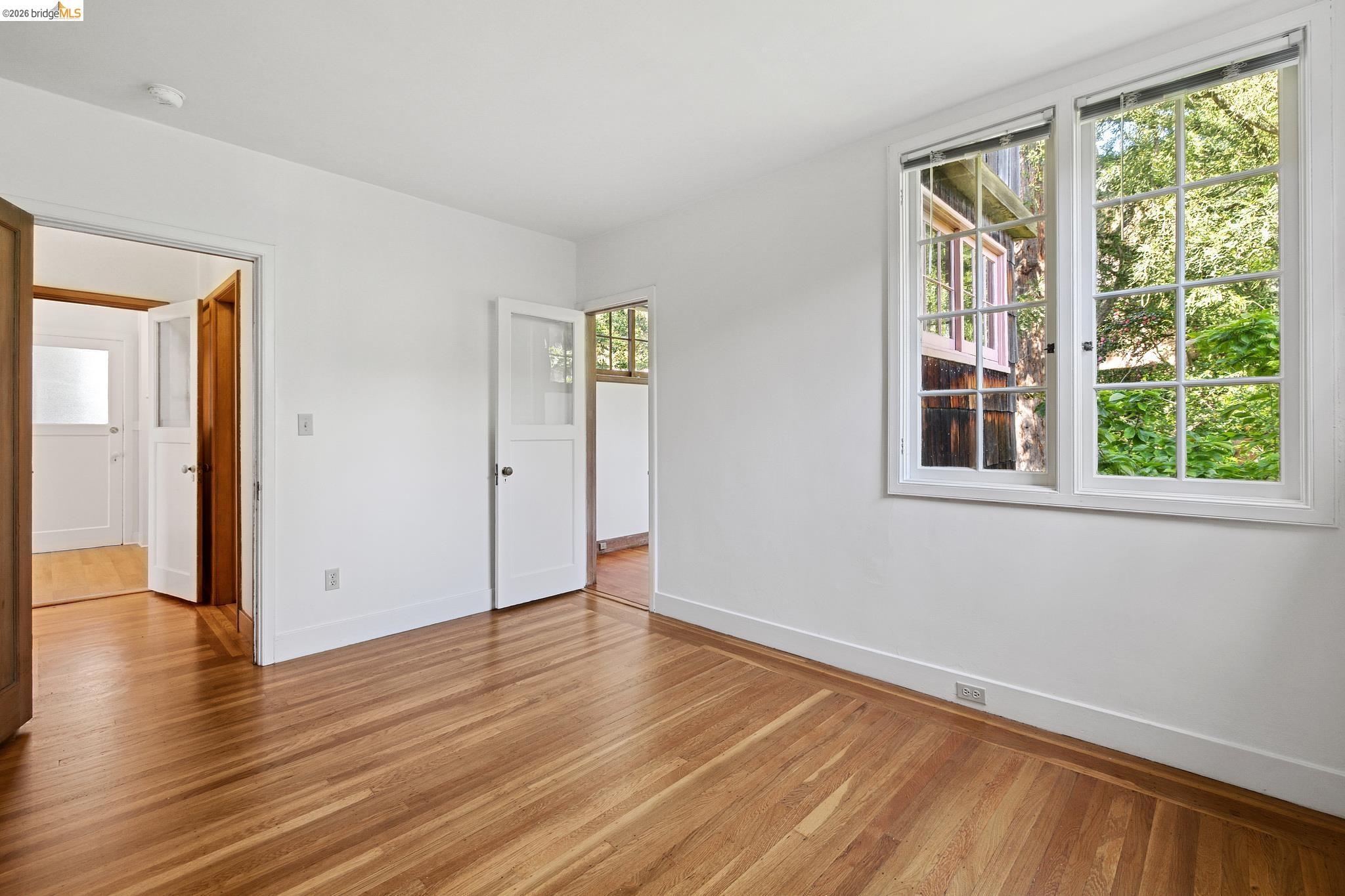 2501 Rose Walk Berkeley, CA 94708 - Photo 44 of 60 a view of an empty room with wooden floor and a window