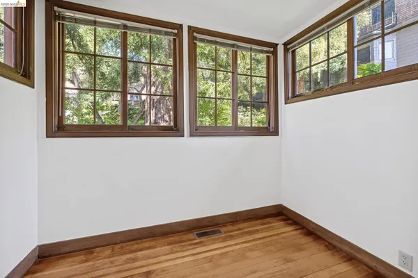 a view of a hallway with wooden floor and a window