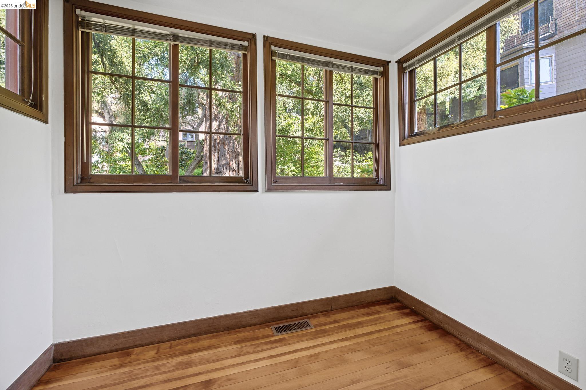 2501 Rose Walk Berkeley, CA 94708 - Photo 45 of 60 a view of an empty room with wooden floor and a window