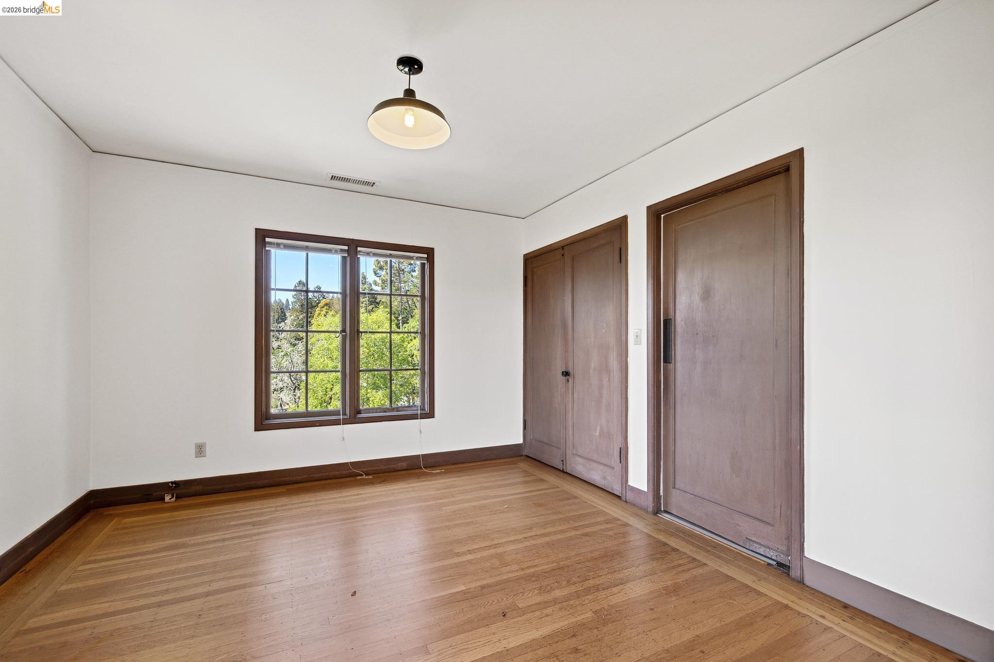 2501 Rose Walk Berkeley, CA 94708 - Photo 50 of 60 an empty room with wooden floor and windows