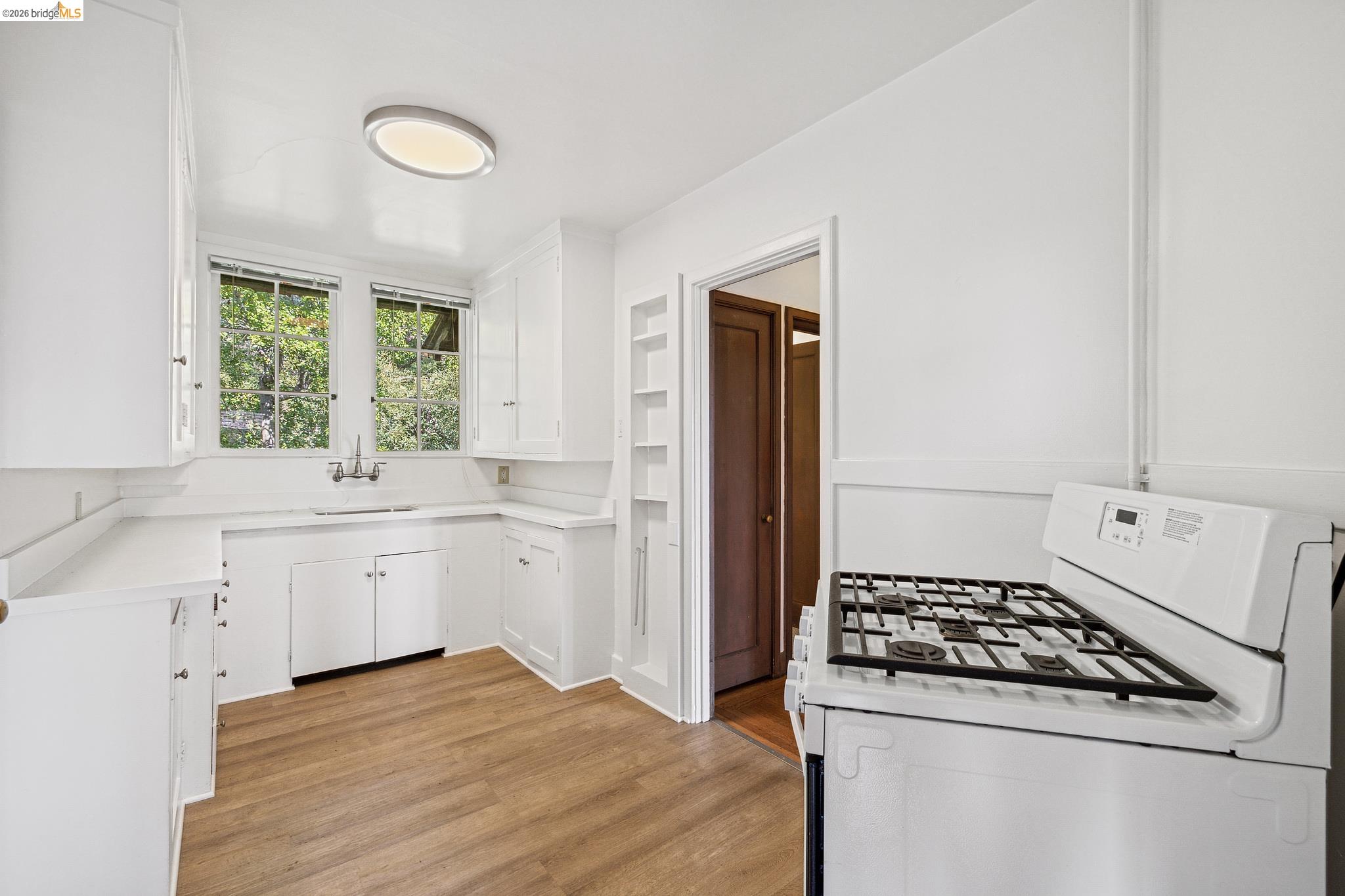 2501 Rose Walk Berkeley, CA 94708 - Photo 55 of 60 a kitchen with white cabinets and appliances