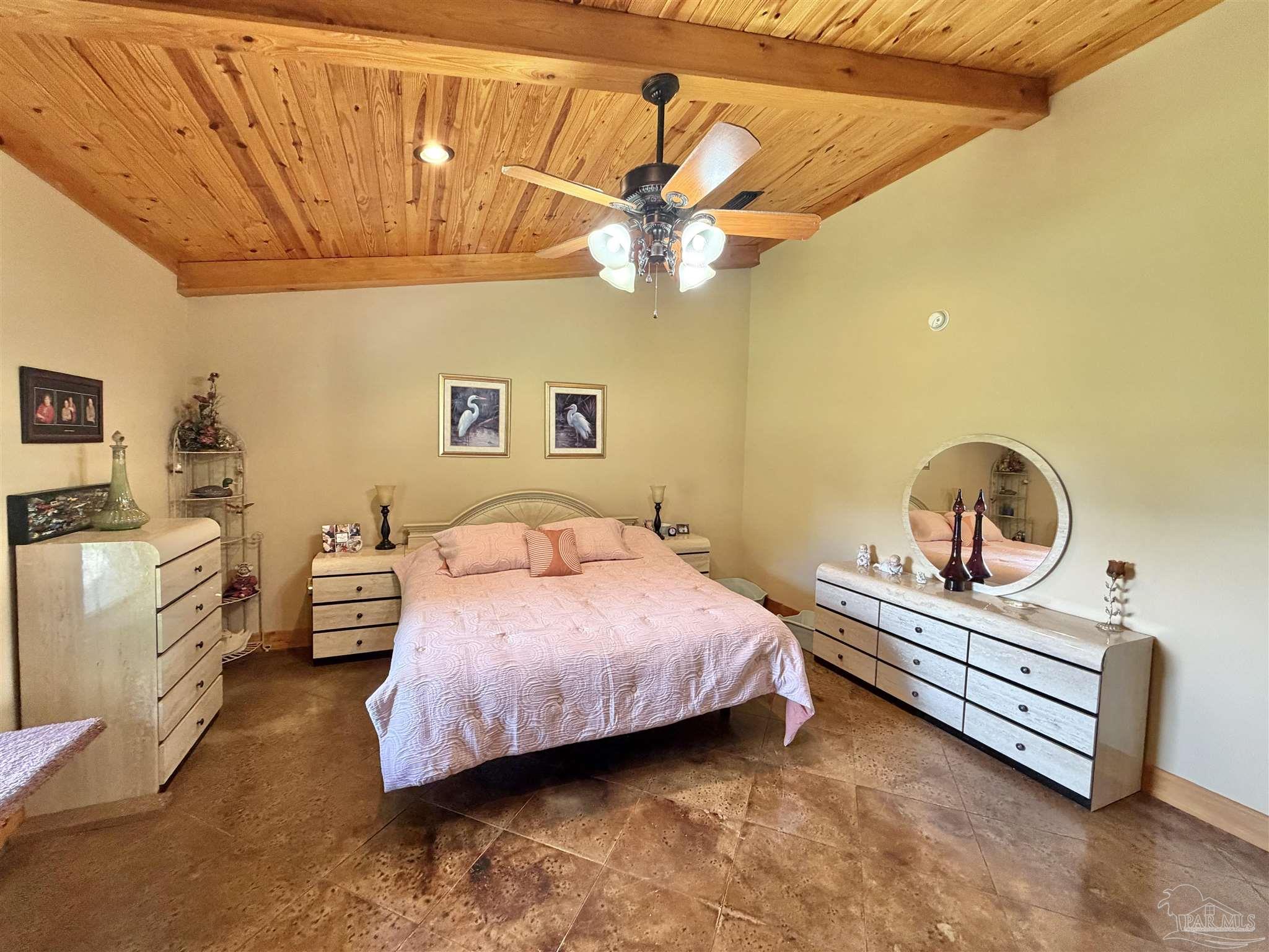 145 Tower Road Uriah, AL 36480 - Photo 14 of 72 a bedroom with a bed and a chandelier