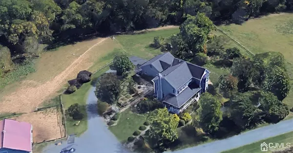 an aerial view of a house with garden space and street view