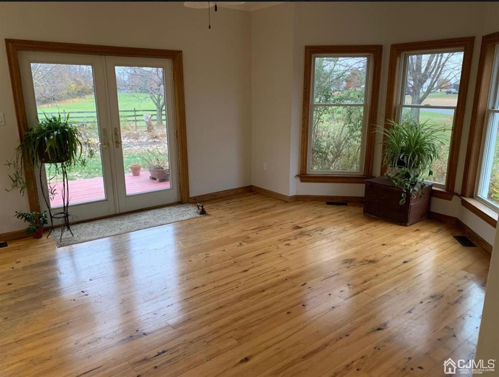 54 Cranbury Neck Road Cranbury, NJ 08512 - Photo 9 of 11 a view of an empty room with wooden floor and a window