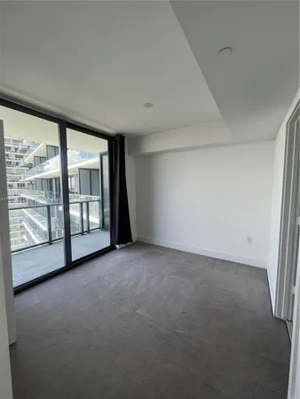 an empty room with large windows and city view