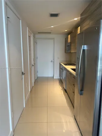 a view of a refrigerator in kitchen and wooden floor
