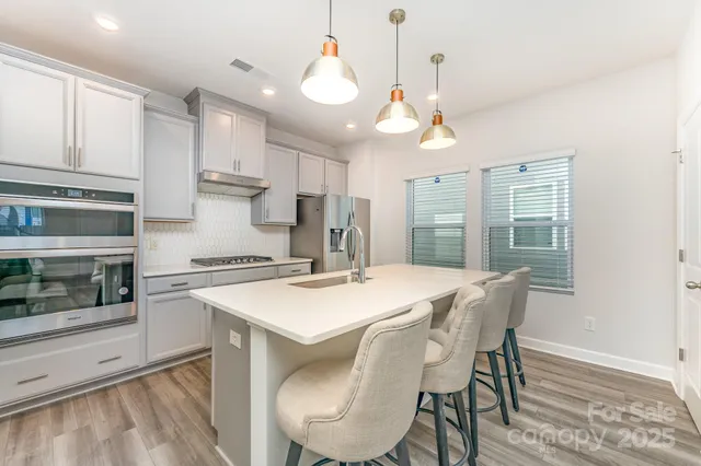 a kitchen with a table chairs stove and microwave