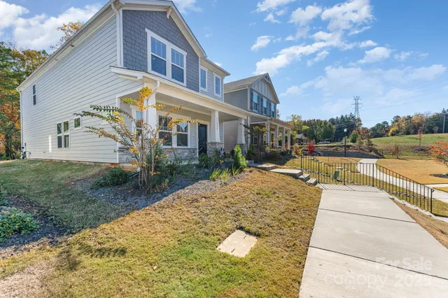 a view of a white house with a yard