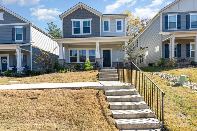 a view of a house with wooden floor next to a yard