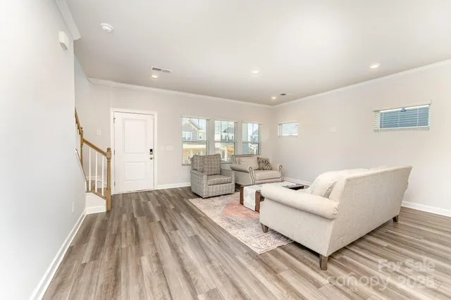a living room with couches and painted walls with wooden floor