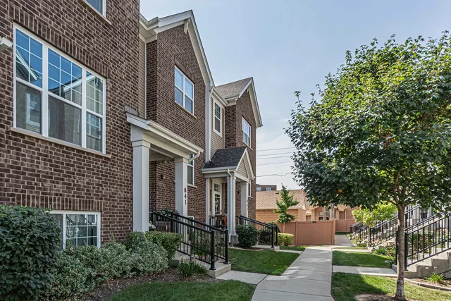 a view of a brick building next to a yard