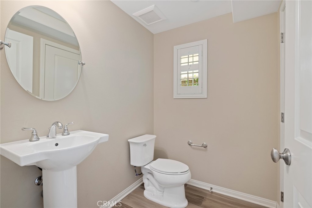 133 Waterleaf Irvine, CA 92620 - Photo 14 of 22 a bathroom with a toilet a sink and mirror