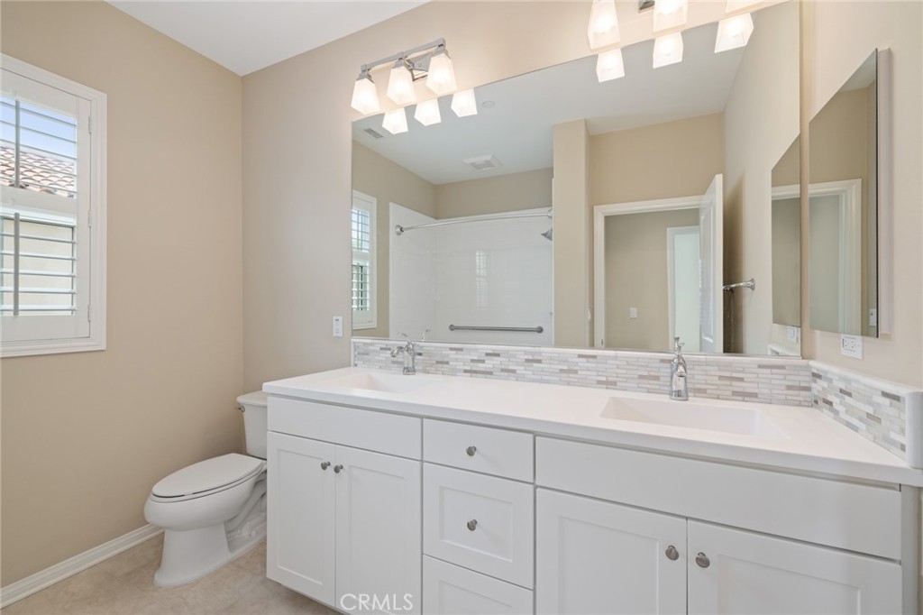 133 Waterleaf Irvine, CA 92620 - Photo 20 of 22 a bathroom with a toilet a sink and mirror