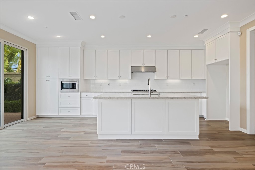 133 Waterleaf Irvine, CA 92620 - Photo 4 of 22 a view of kitchen with wooden cabinet and stainless steel appliances