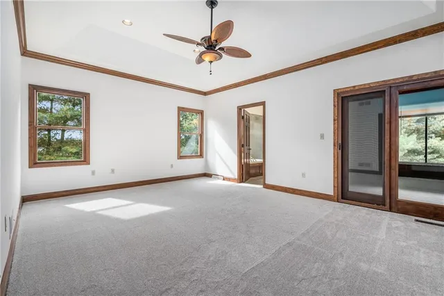 a view of a livingroom with a ceiling fan and window