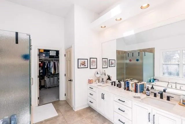 a bathroom with a double vanity sink mirror and shower