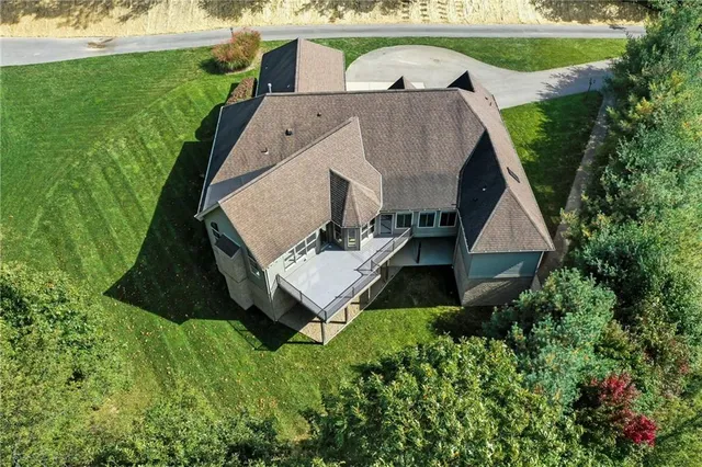 an aerial view of a house with garden space and street view