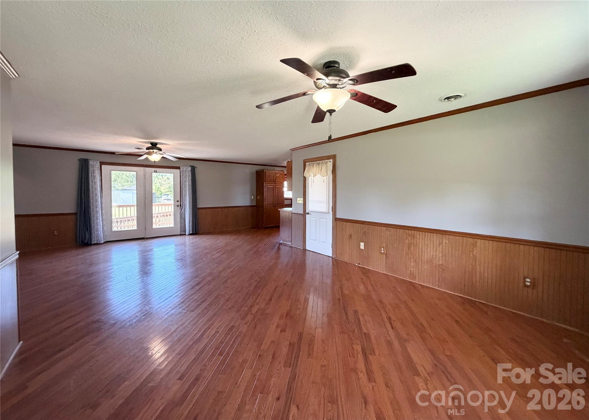 372 Ferry Road Forest City, NC 28043 - Photo 12 of 36 a view of an empty room with wooden floor and a window