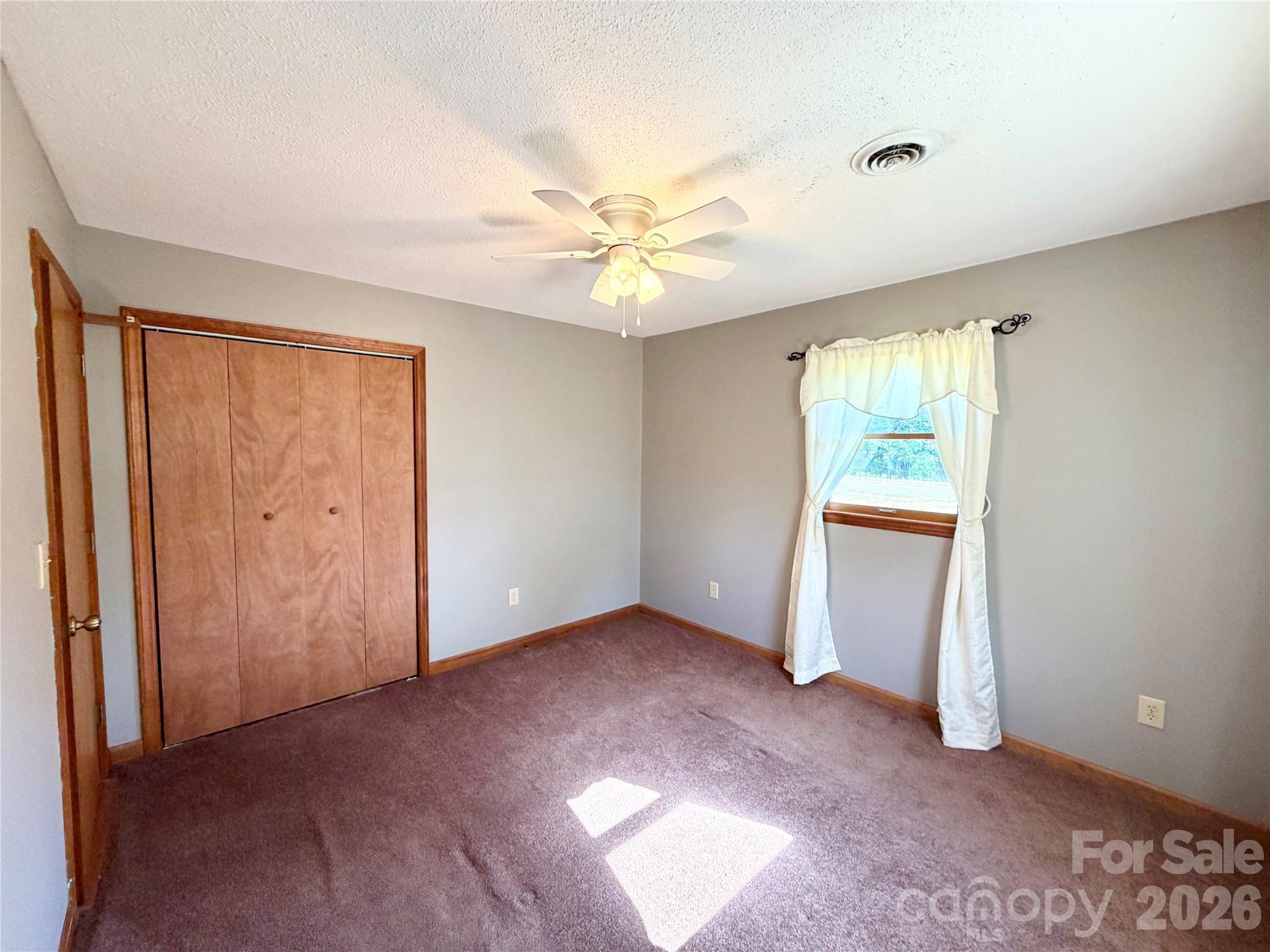 372 Ferry Road Forest City, NC 28043 - Photo 15 of 36 an empty room with windows and fan