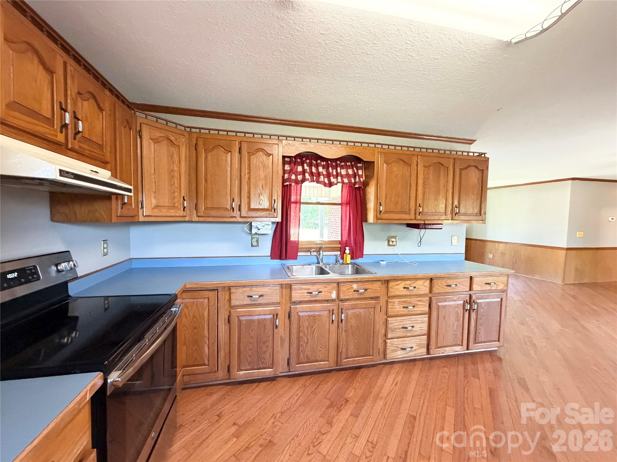 372 Ferry Road Forest City, NC 28043 - Photo 5 of 36 a kitchen with stainless steel appliances granite countertop a sink a stove and a refrigerator