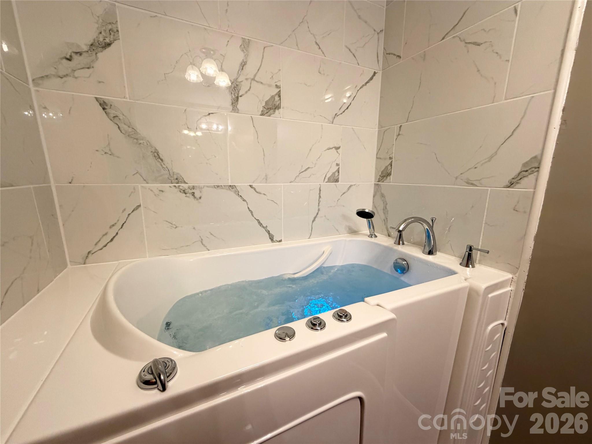 372 Ferry Road Forest City, NC 28043 - Photo 8 of 36 a bathroom with a sink a large mirror and bathtub
